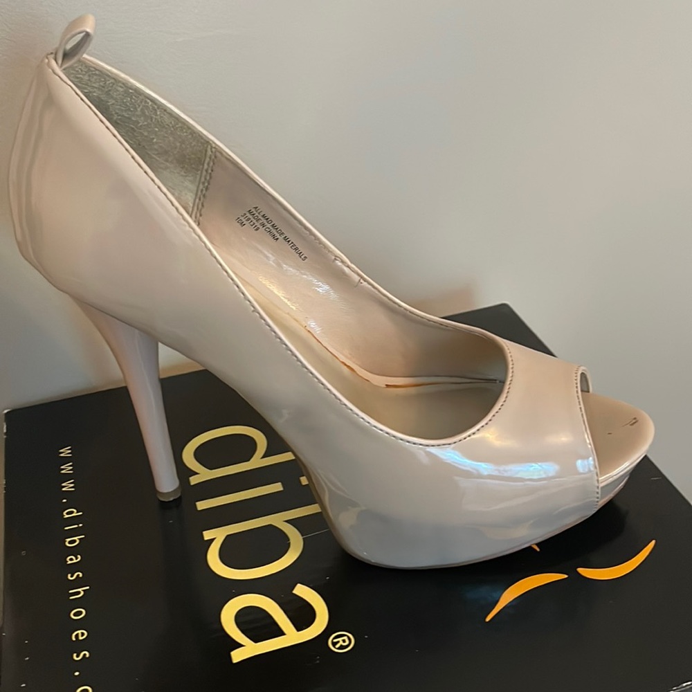 Nude peep toe heels . Slight scuff marks